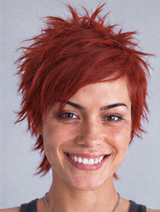 Kriszta, with spiky red hair, smiling