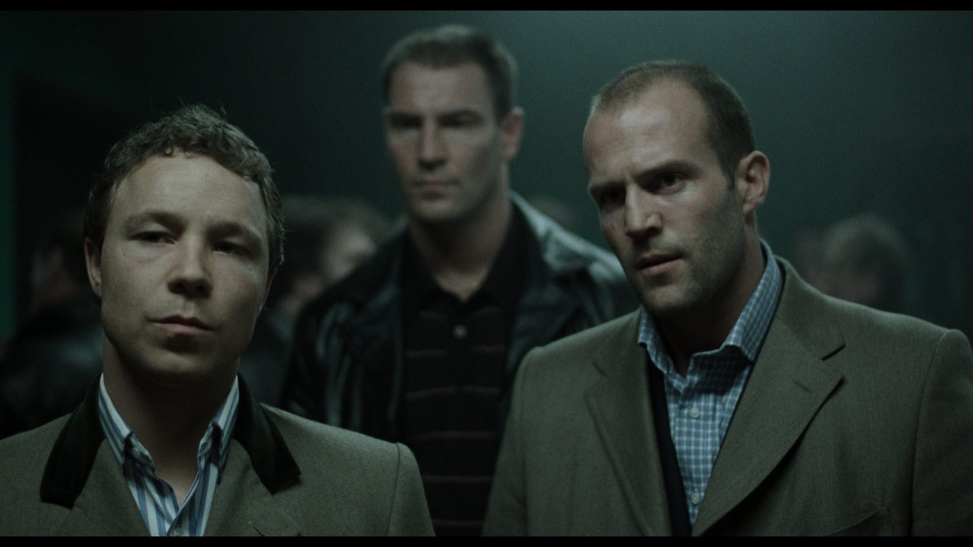 Snatch (2000): three men in a dim, green-grey bar
